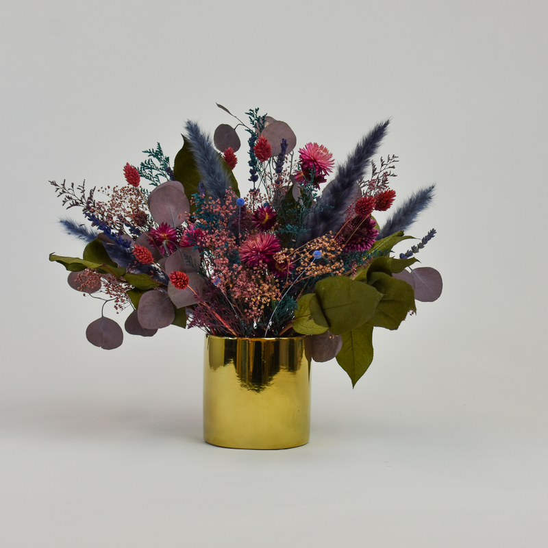 Tropics by Eos Blooms: vibrant preserved flowers in a gold vase for lasting modern style.